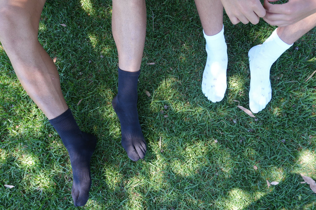 Japanese soccer player wearing five-toe grip socks on the training pitch