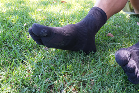 Close-up of black five-toe grip socks