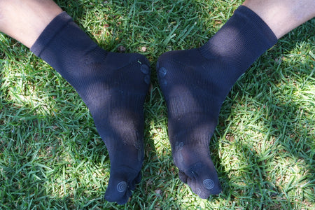 Close-up of black five-toe grip socks feet together